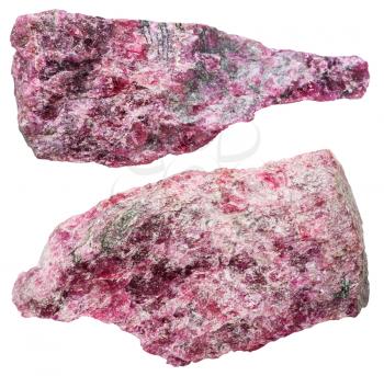 macro shooting of collection natural rock - two eudialyte (almandine spar) mineral stones isolated on white background