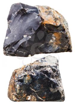 macro shooting of natural mineral stone - two pieces of black flint (chert) rock isolated on white background