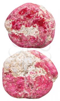 macro shooting of natural mineral stone - two tumbled Thulite (rosaline, pink zoisite) gemstones isolated on white background