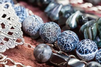 detail of gray blue necklace from natural gemstones - Dragon Veins Agate and hematite beads close up