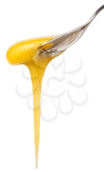 yellow honey flows down from teaspoon close up isolated on white background