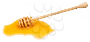 puddle of clear honey and wooden spoon isolated on white background