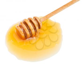 puddle of transparent honey and wooden stick close up isolated on white background