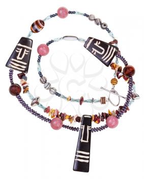 african style necklace from natural gemstones ( mookaite, jasper, rhodonite, agate) and carved bone figures isolated on white background