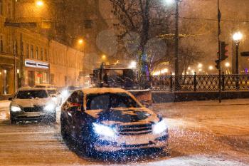 snowfall in night city - cars traffic under snow on sretensky boulevard, Moscow