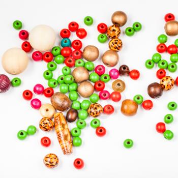 above view of many painted wooden beads on white background