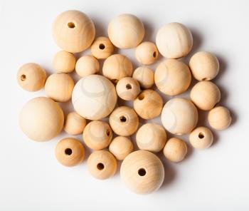 top view of many natural wooden beads on white background