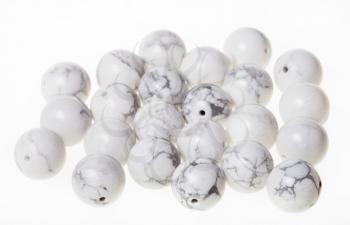 many beads from white howlite gemstone on white background