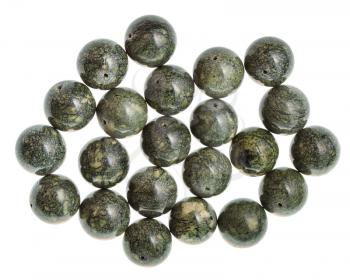 top view of several beads from serpentine gemstone on white background