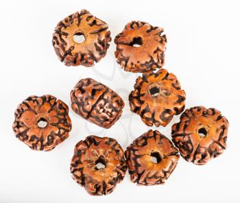 several wooden beads from Rudraksha tree seeds on white background