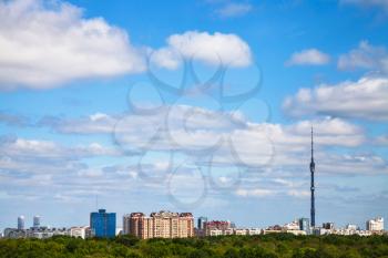 city and green forest under cloudy blue sky in summer day