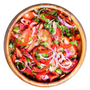 top view of salad from fresh tomatoes, cucumbers, red onion in wooden bowl isolated on white background