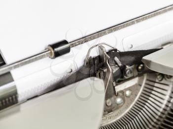 side view of typebar types ink ribbon in old typewriter