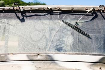 dirty and broken windshield of off-road vehicle in sunny summer day