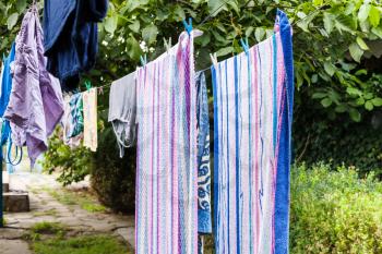 towels and linen drying in the courtyard in open air in summer day