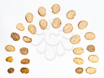 many sliced bread baguettes in arch shape on white background