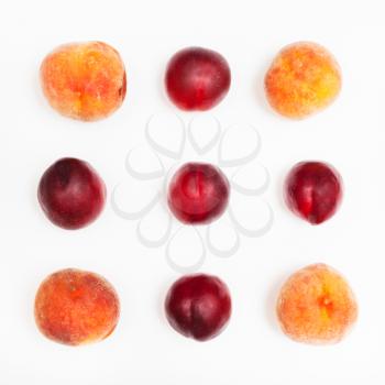 ripe nectarines and peaches arranged in square on white background