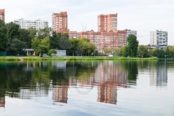 green recreation area on shore of the city pond. Big Garden (Academic) Pond, Moscow