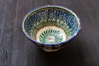 one traditional central asian bowl on dark brown board