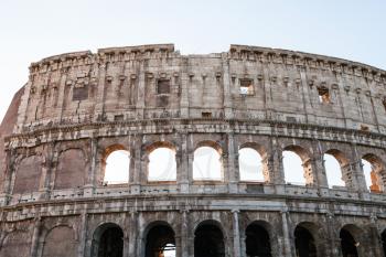 travel to Italy - wall of ancient roman amphitheater Colosseum in Rome city in evening