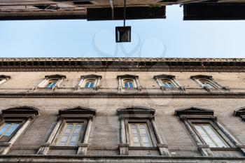 travel to Italy - bottom view of dark facades of old houses on narrow street ( Via dei Farnesi) in Rome city