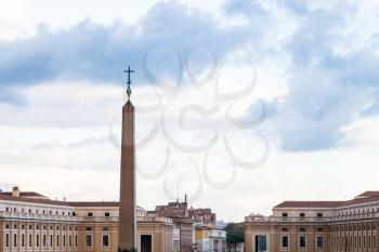 travel to Italy - obelisk with cross on Saint Peter's Square (Piazza San Pietro) in Vatican city in evening