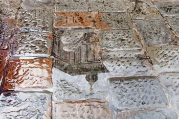 travel to Italy - Baptistery reflected in puddle on pavement on piazza san giovanni near Florence Baptistery in rain