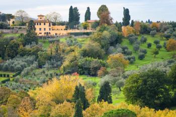 travel to Italy - above view of green and yellow gardens in outskirts of Florence city from Piazzale Michelangelo in Florence city in autumn