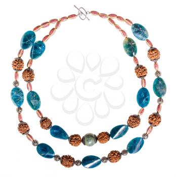 top view of round necklace from kyanite and serpentine natural gem stones, ceramic beads, rudraksha tree seeds isolated on white background