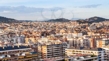 above view of urban houses in Barcelona city on sunset