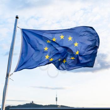 european union flag fluttering on wind in evening
