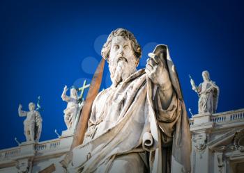 Travel to Italy - Statue of Apostle Paul near St Peter Basilica in Vatican city in sunny winter day. The statue of St Paul was sculpted in 1838 by Adamo Tadolini