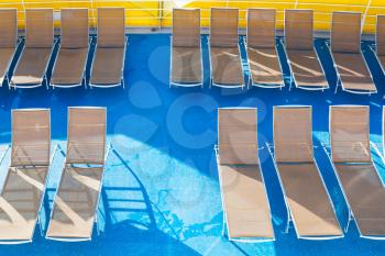 top view of empty chairs in sunbathing area on stern of cruise liner