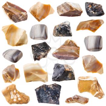 collection of tumbled and raw flint mineral stones isolated on white background