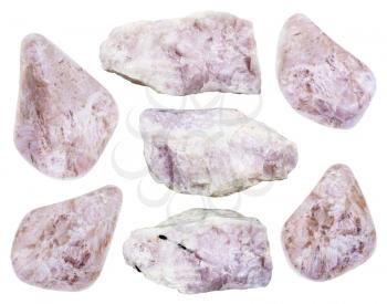 collection of raw and tumbled ussingite mineral stones isolated on white background
