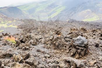travel to Italy - hardened lava close up on lava field on Mount Etna in Sicily in summer day
