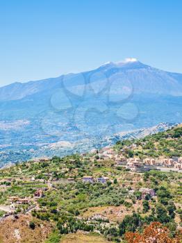 travel to Italy - view of villages on green hills and Etna volcano in Sicily
