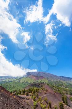 travel to Italy - blue sky with white clouds over old craters of Etna volcano in Sicily