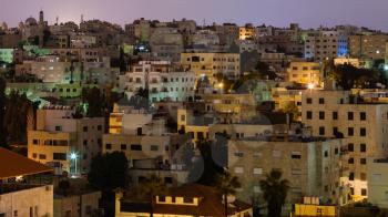 Travel to Middle East country Kingdom of Jordan - urban houses in Amman city in night