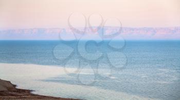 Travel to Middle East country Kingdom of Jordan - pink sunrise over Dead Sea in winter morning