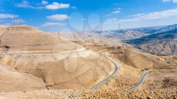 Travel to Middle East country Kingdom of Jordan - King's highway in mountain near Al Mujib dam on Wadi Mujib river (River Arnon) near Dhiban town in winter