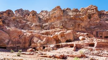 Travel to Middle East country Kingdom of Jordan - ancient tombs in rocks on Street of Facades in Petra town in winter