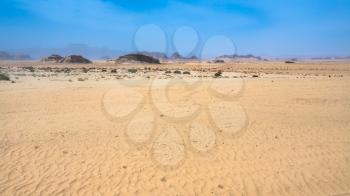 Travel to Middle East country Kingdom of Jordan - sand surface of Wadi Rum desert in sunny winter day