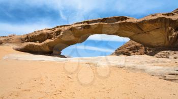 Travel to Middle East country Kingdom of Jordan - view of bridge sandstone rock in Wadi Rum desert in sunny winter day