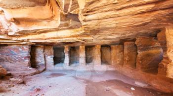 PETRA, JORDAN - FEBRUARY 21, 2012: interior of sandstone rock-cut tombs (Kokh) in Petra town. Rock-cut town Petra was established about 312 BC as the capital city of the Arab Nabataean