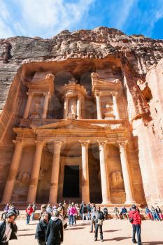 PETRA, JORDAN - FEBRUARY 21, 2012: tourists on plaza of al-Khazneh temple (The Treasury) in Petra city. Rock-cut town Petra was established about 312 BC as the capital city of the Arab Nabataean