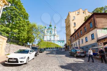 KIEV, UKRAINE - MAY 5, 2017: people on Andriyivskyy Descent and view of St Andrew's Church in Kiev city in spring. The church was constructed in 1747-1754 by architect Bartolomeo Rastrelli