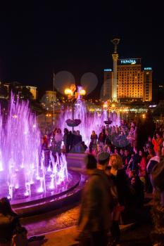 KIEV, UKRAINE - MAY 4, 2017: tourists at the opening of the singing fountains on Maidan Nezalezhnosti (Independence square) of Khreshchatyk street in Kiev city in night.