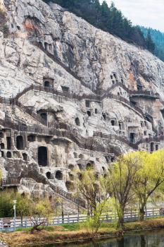 travel to China - view of West Hill of Chinese Buddhist monument Longmen Grottoes (Dragon's Gate Grottoes, Longmen Caves) in spring season