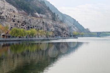 travel to China - view of Yi river and West Hill of Chinese Buddhist monument Longmen Grottoes (Dragon's Gate Grottoes, Longmen Caves) in spring season